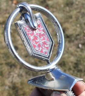 461979 General Motors / Chevrolet Oem 1976-1977 Monte Carlo Header Panel Hood Ornament Emblem