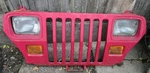 87/95 Jeep Wrangler Grill/headlight Assembly. Factory Red.. Fixed Price $175.00.