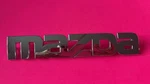 00 03 06 Mazda Mpv Liftgate Emblem LC62 51710. Fixed Price $14.00.